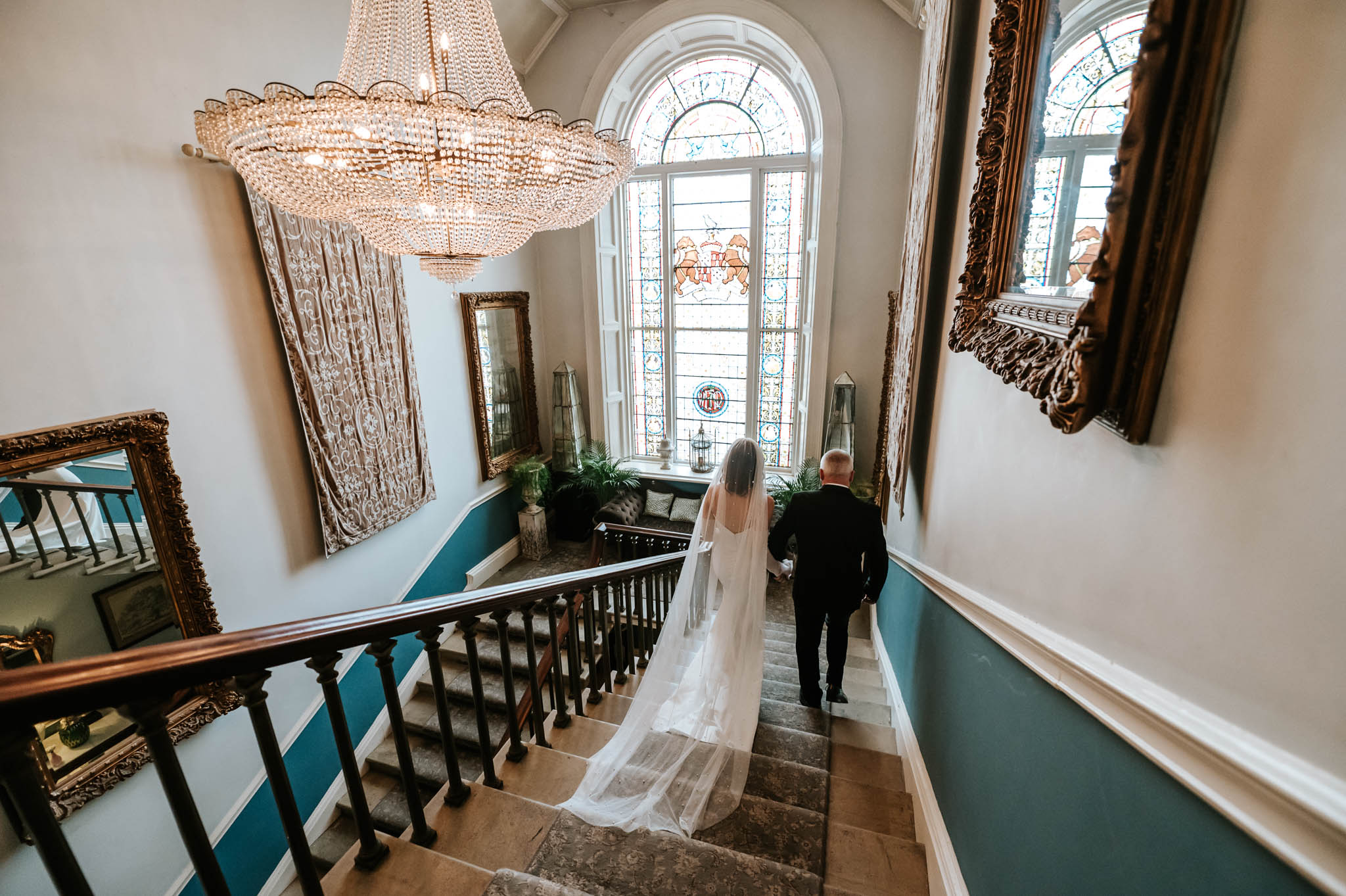 Wedding Timeline Tips Every Couple Should Know 1 Wedding Timeline. Bride and Daddy descending staircase elegantly.